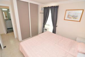 1 dormitorio con cama rosa y ventana en Apartment in Las Plataneras, en Los Cristianos
