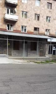 an empty street in front of a brick building at Jermuk Mini Apartment in Jermuk