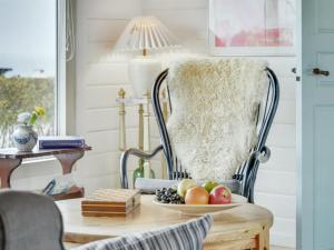 una mesa con una silla con un plato de fruta. en Holiday Home Ylvie - 150m from the sea in Funen by Interhome, en Frørup