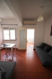 a living room with a couch and a table at Oriente DNA Studios VI in Lisbon