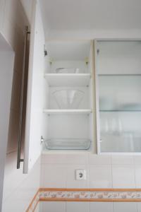 a bathroom with a toilet in a white cabinet at Oriente DNA Studios VI in Lisbon