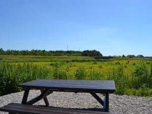 a wooden picnic table sitting on a gravel field at Apartment Esja - 22km from the sea in Western Jutland by Interhome in Bredebro