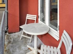 a table and a chair sitting next to a window at Apartment Esja - 22km from the sea in Western Jutland by Interhome in Bredebro