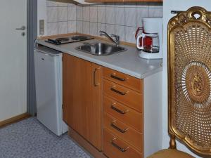 a small kitchen with a sink and a refrigerator at Apartment Esja - 22km from the sea in Western Jutland by Interhome in Bredebro