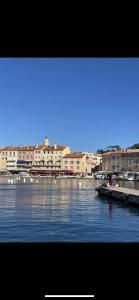 a view of a body of water with buildings and boats at LA DOLCE VITA MAZET A GASSIN GOLFE DE SAINT TROPEZ in Gassin