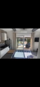 a kitchen and living room with a large window at LA DOLCE VITA MAZET A GASSIN GOLFE DE SAINT TROPEZ in Gassin +32 photos