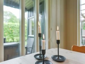 dos velas sentadas sobre una mesa en Holiday Home Saima - 25km from the sea in Western Jutland by Interhome en Toftlund