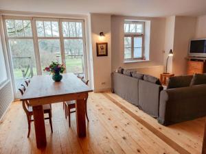 a living room with a table and a couch at Holiday Home Parkblick by Interhome in Heyda