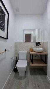 a bathroom with a white toilet and a sink at ARQ Home Arrecife in Arrecife
