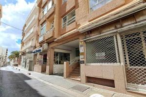 a building on a city street with a store at ARQ Home Arrecife in Arrecife