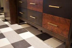 a dresser in a room with a checkered floor at LiA Hotel in San Carlos