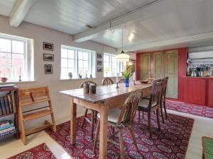 a dining room with a wooden table and chairs at Holiday Home Saarah - 25km from the sea in Western Jutland by Interhome in Bredebro