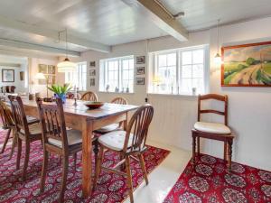 a dining room with a wooden table and chairs at Holiday Home Saarah - 25km from the sea in Western Jutland by Interhome in Bredebro