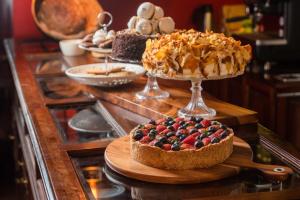 a table topped with cakes and desserts on a counter at Dreams Hotel Boutique in Arequipa