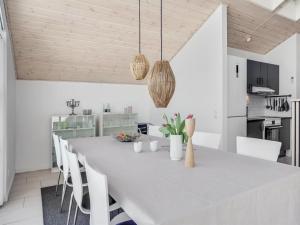 a white dining room with a white table and chairs at Holiday Home Asel - 4km from the sea in NW Jutland by Interhome in Brovst