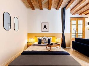 a bedroom with a large bed and a couch at Spacious apartment in the Gothic in Barcelona