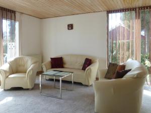 a living room with two couches and a coffee table at Holiday Home Altje - 400m from the sea by Interhome in Egå