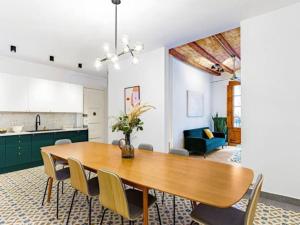 a kitchen and dining room with a wooden table and chairs at Spacious apartment in the Gothic in Barcelona