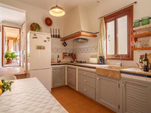 a kitchen with a white refrigerator and a sink at Holiday Home Can Salom by Interhome in Binissalem