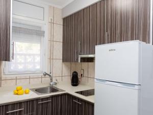 a kitchen with a white refrigerator and a sink at Holiday Home Eden Park 2 by Interhome in Miami Platja