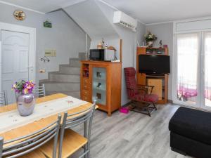 a living room with a table and a television at Holiday Home Eden Park 2 by Interhome in Miami Platja