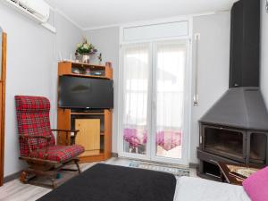 a living room with a chair and a television at Holiday Home Eden Park 2 by Interhome in Miami Platja