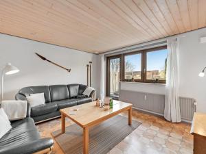 a living room with a couch and a table at Apartment Evina - 17km to the inlet in Western Jutland by Interhome in Skjern