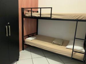 a couple of bunk beds in a room at Pousada Internacional EAS Airport 10min in Guarulhos