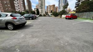 a parking lot with parked cars in a city at Esperanto 17. in Benidorm