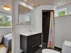 a bathroom with a sink and a shower at Holiday Home Ødger - 150m to the inlet by Interhome in Åbybro