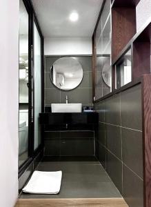 a bathroom with a sink and a mirror at Hanoi Saga Hotel in Hanoi
