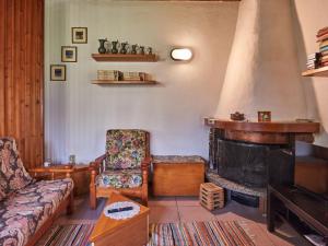 a living room with a couch and a fireplace at Chalet Lucia by Interhome in Claino