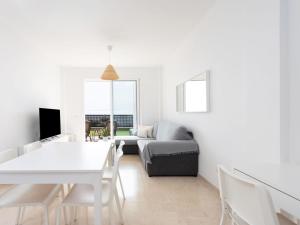 A television and/or entertainment centre at Apartment Playa Negra II by Interhome