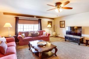 a living room with a couch and a tv at Homey Deadwood Apartment in Convenient Spot! in Deadwood