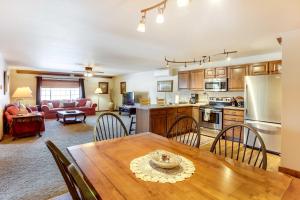 a kitchen and living room with a wooden table and chairs at Homey Deadwood Apartment in Convenient Spot! in Deadwood