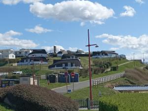 une croix sur le côté d'une route avec des maisons dans l'établissement Détente sur la Côte d'Opale, à Équihen-Plage