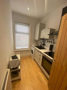 a kitchen with a sink and a stove top oven at Amazing Two Bedroom Apartment - SR in Southport