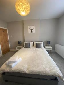 a bedroom with a large bed with two tables at Amazing Two Bedroom Apartment - SR in Southport