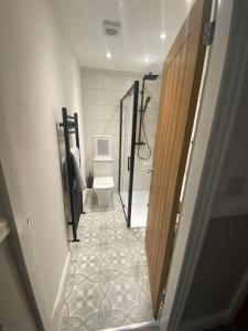a hallway with a bathroom with a toilet and a door at Amazing Two Bedroom Apartment - SR in Southport