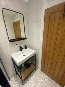 a bathroom with a white sink and a mirror at Amazing Two Bedroom Apartment - SR in Southport