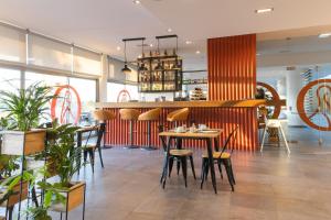 a restaurant with a table and chairs and a bar at Pelican Alvor in Alvor