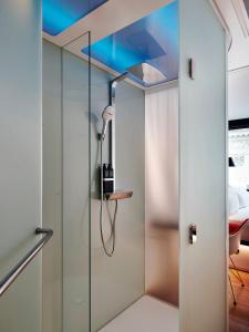 a shower with a glass door with a shower head at citizenM Paris Opera in Paris