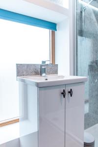 a bathroom with a sink and a shower at The Stable in Canterbury