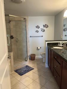 a bathroom with a shower and a sink and a toilet at Miramar Condominiums in Ocean City