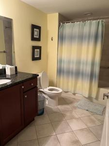 a bathroom with a toilet and a sink and a shower at Miramar Condominiums in Ocean City