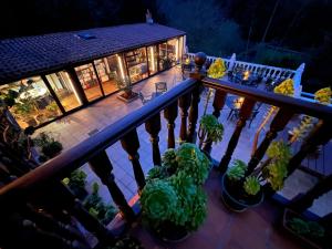 an overhead view of a house with a balcony with plants at Posada La Vieja Escuela in La Revilla