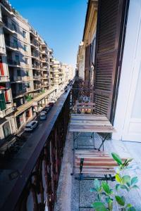 two benches sitting on a balcony of a building at Daniel's Apartment in Bari