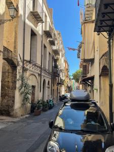 a car parked on a street in an alley at Home Porta Di Castro in Palermo