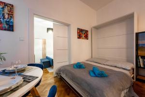 a bedroom with a bed and a table with blue shoes on it at Mojmirova Apartment Kosice Center in Košice