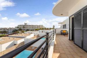 a balcony of a house with a swimming pool at Villa RamiMedi 4 in Tías